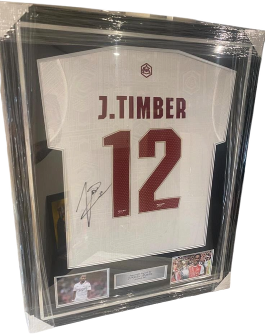 Beautifully framed and signed Jurrien Timber Arsenal third shirt from the 2025/26 title-winning season with a large autograph on the back.