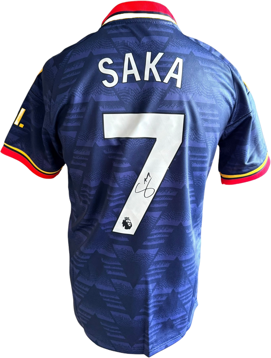 Authentic hand-signed Bukayo Saka Arsenal blue bruised banana away jersey from the 2026/27 season featuring a clear signature on the back.