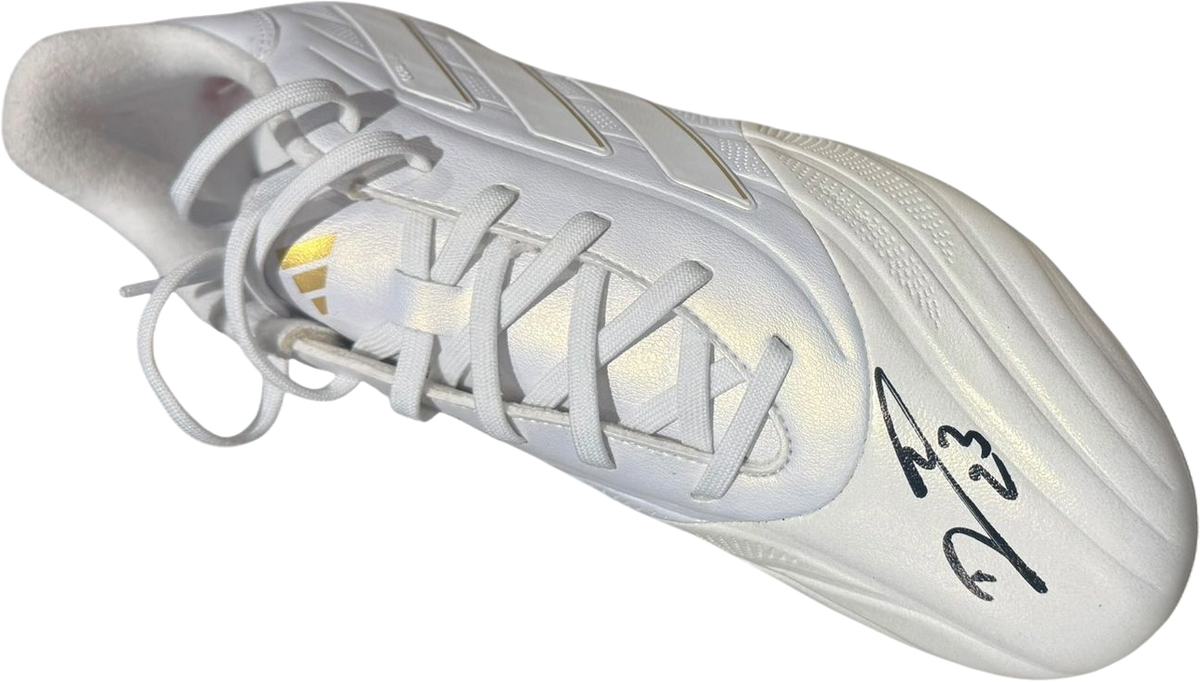 Studio photograph of the left boot hand-signed by Emiliano Martinez, showcasing the authentic signature clearly on the side.