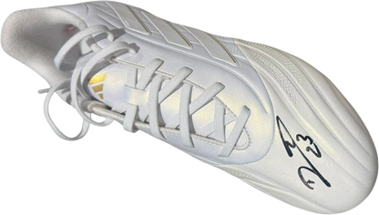 Studio photograph of the left boot hand-signed by Emiliano Martinez, showcasing the authentic signature clearly on the side.
