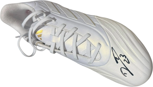 Studio photograph of the left boot hand-signed by Emiliano Martinez, showcasing the authentic signature clearly on the side.