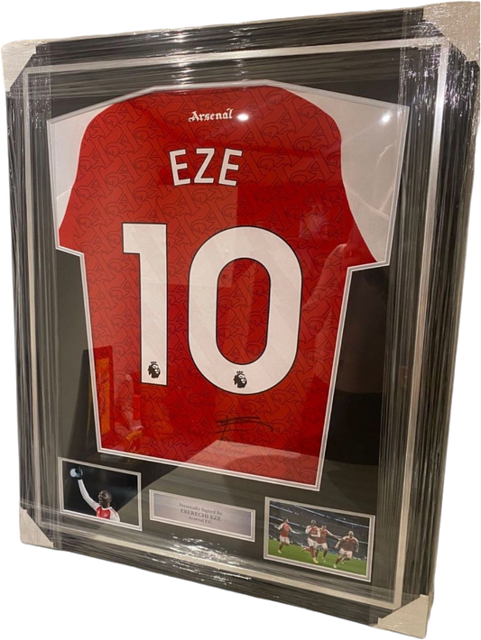 Framed and hand-signed Eberechi Eze Arsenal 2025/2026 home shirt featuring authentic autograph and inset images celebrating goals against Tottenham.