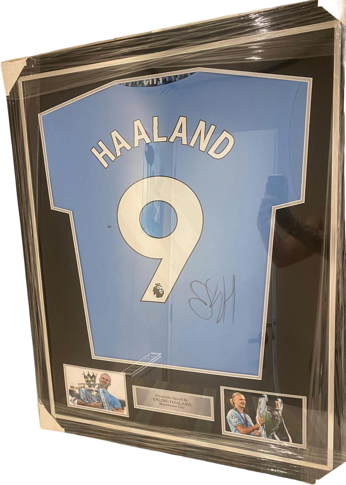 Professionally framed and authentic hand-signed Erling Haaland Manchester City home jersey with a clear signature across the back.