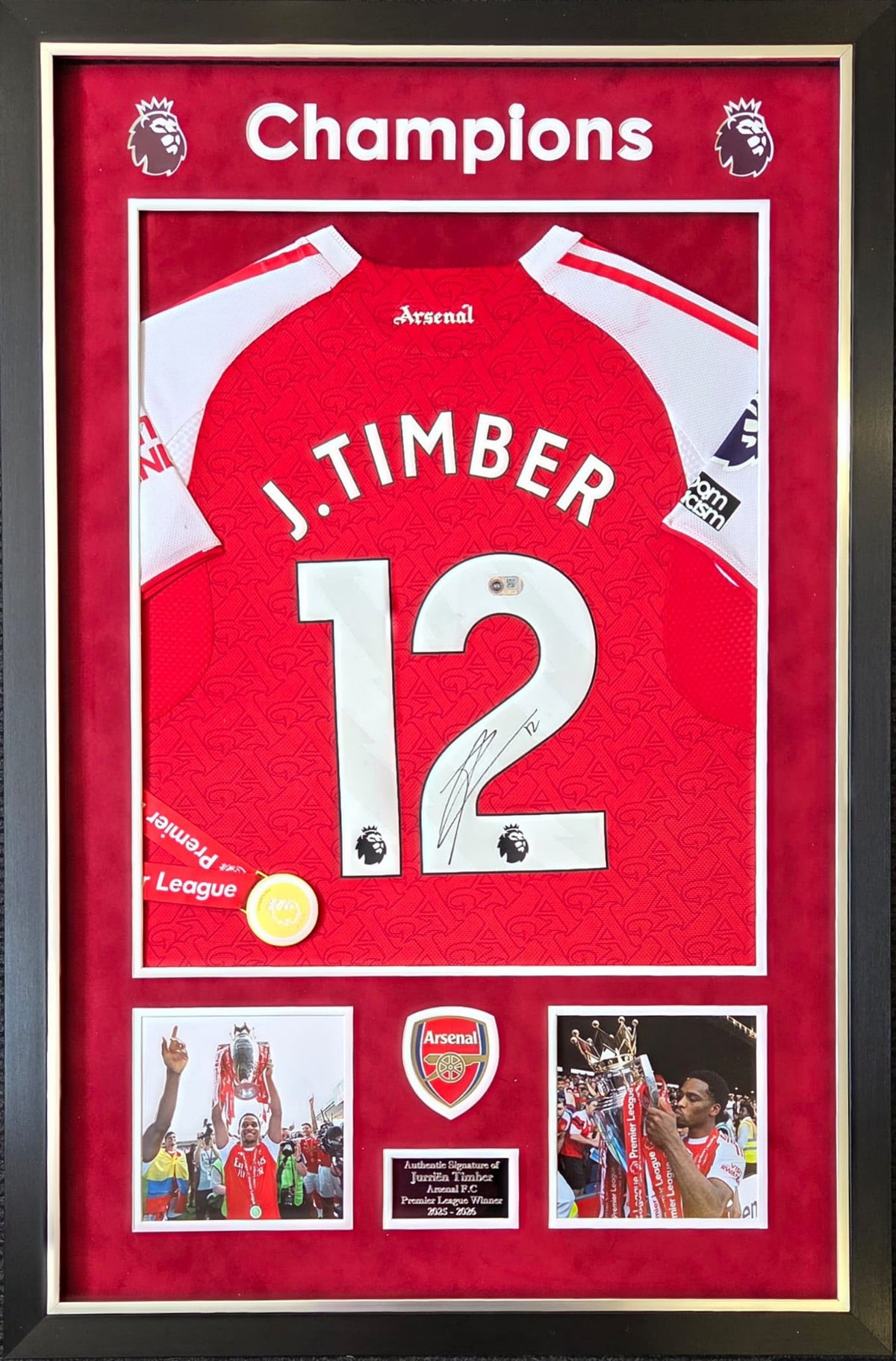 Premium framed display featuring a hand-signed Jurrien Timber Arsenal home shirt with 2025/26 Champions details and a replica league medal.