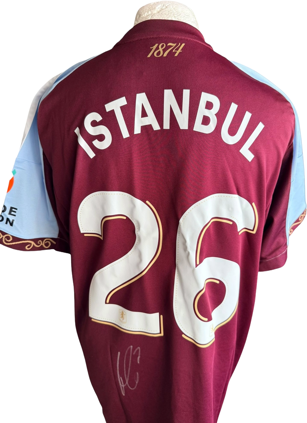 Authentic hand-signed John McGinn Aston Villa home jersey featuring Istanbul 26 custom printing and a clear signature on the back.