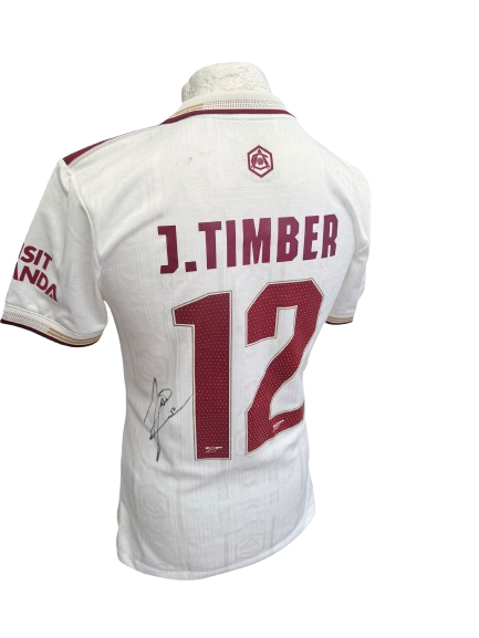 Close-up angled view highlighting the crisp authentic autograph of Jurrien Timber on the front of the Arsenal 2025/2026 white third kit.