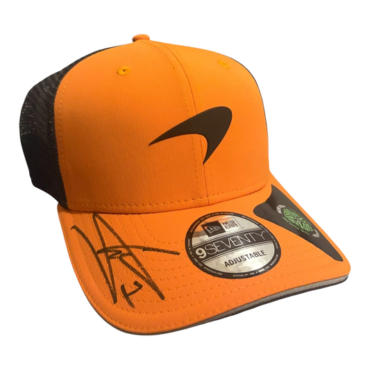 Side 45-degree angle view of the signed Lando Norris McLaren baseball cap showcasing the hand-signed autograph clearly across the peak