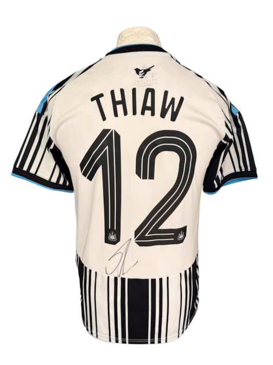 Back view of the signed Malick Thiaw Newcastle United home shirt 2026/27 displaying a hand-signed autograph across the back