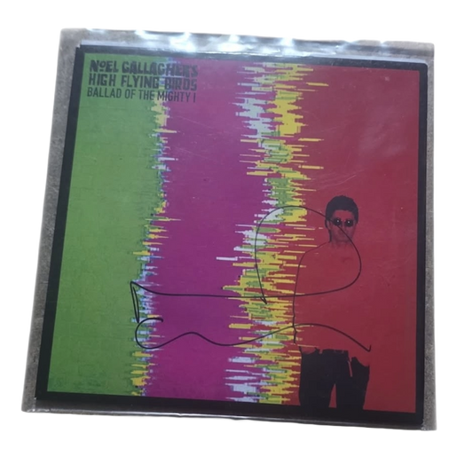 Front cover sleeve of the signed Noel Gallagher Ballad of the Mighty I vinyl record featuring his bold autograph