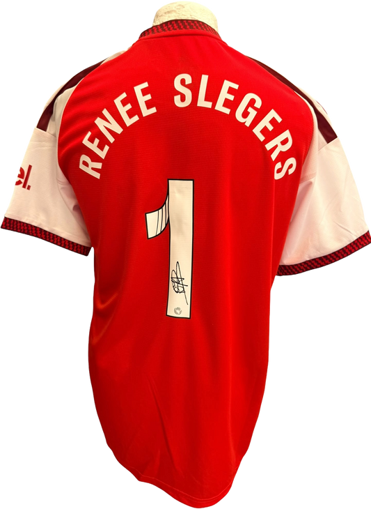 Close up shot of an authentic hand-signed autograph by head coach Renee Slegers across the front of the red and white Arsenal 2026/27 home shirt.