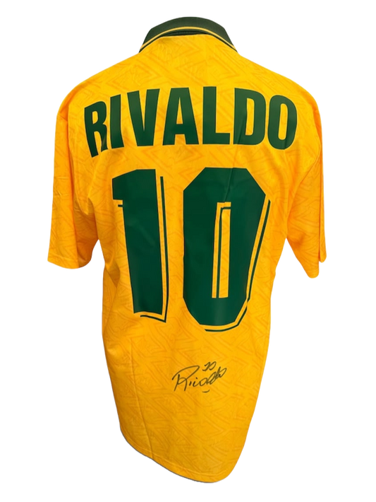 Back view of the signed Rivaldo Brazil debut shirt displaying the iconic yellow design with a hand-signed autograph on the back