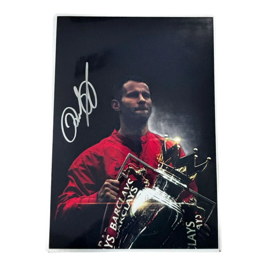 Signed Ryan Giggs Manchester United artwork depicting him lifting the Premier League trophy, autographed in permanent marker.