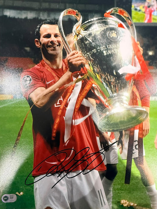 Ryan Giggs celebrating with the Champions League trophy in Moscow 2008, hand-signed in permanent marker.