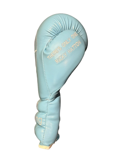 Close up view of boxing glove thumb with embroidered tribute text reading There's only one Ricky Hatton.