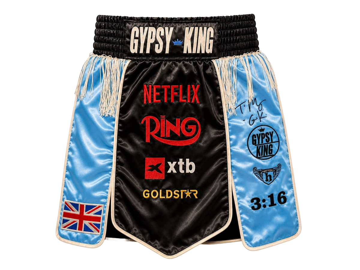 Front view of signed Tyson Fury Gypsy King boxing shorts showing the autograph and logo details.