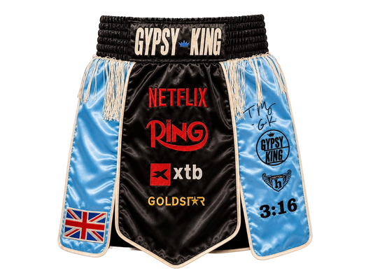 Front view of signed Tyson Fury Gypsy King boxing shorts showing the autograph and logo details.
