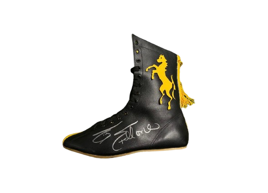 A hand-signed Sylvester Stallone Rocky Balboa Italian Stallion boxing boot in gold and black with a clear autograph.