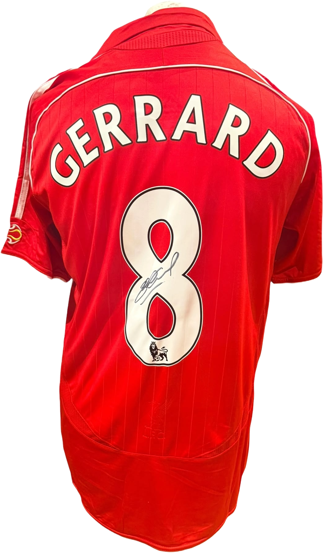 Rear view of a 2006-08 replica Liverpool home shirt hand-signed by captain Steven Gerrard, displayed alongside the Certificate of Authenticity.