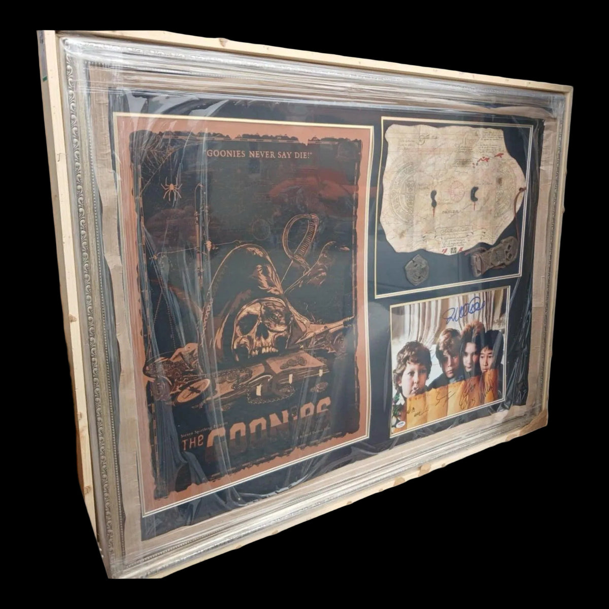Framed "The Goonies" movie display featuring authentic hand-signed autographs from cast members including Sean Astin (Mikey) and Josh Brolin (Brand), set against a classic movie poster background.