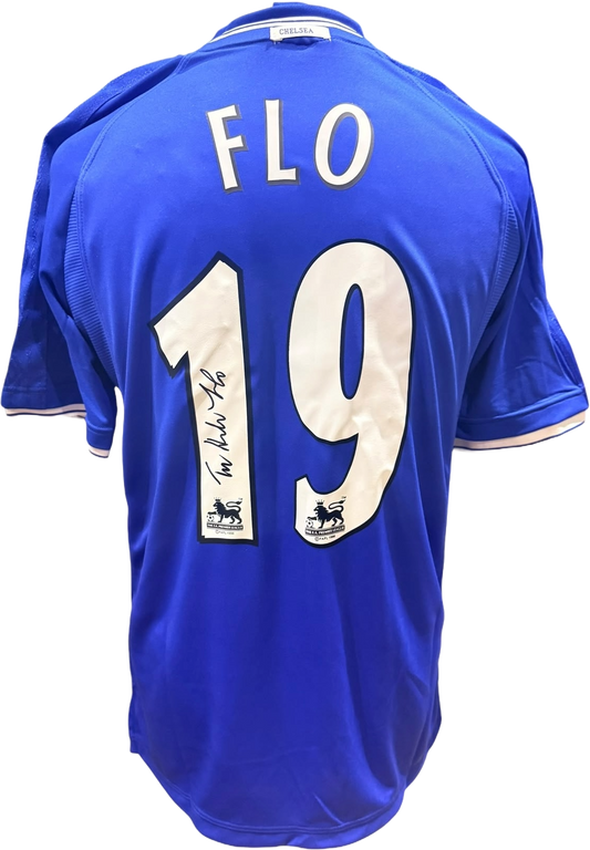 Rear view of a replica retro Chelsea home shirt hand-signed by striker Tore André Flo, displayed alongside the Certificate of Authenticity.