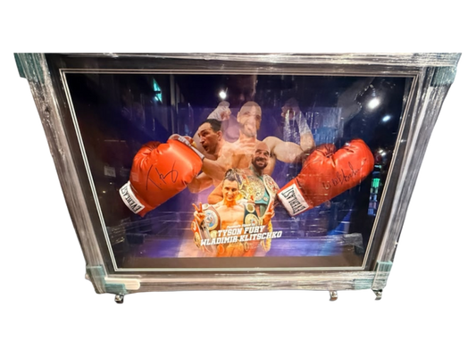 Signed Tyson Fury and Wladimir Klitschko dual framed boxing gloves featuring hand-signed autographs from both heavyweight champions set against bespoke artwork