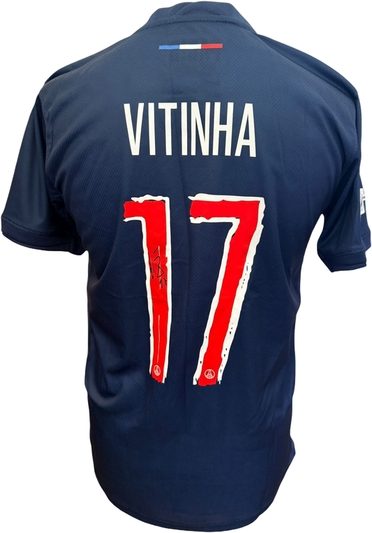 The reverse of the blue PSG shirt showing Vitinha's name and number alongside his clear hand-signed autograph in black marker.